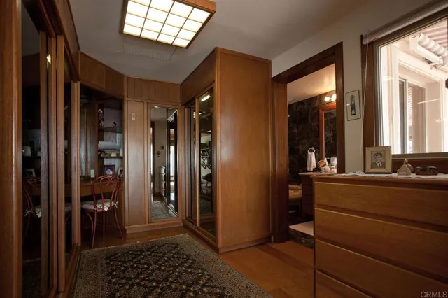 a room with mirror and a glass door shower