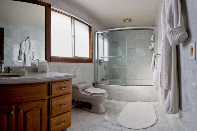a bathroom with a toilet sink and shower