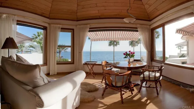 a dining room with furniture a chandelier and wooden floor
