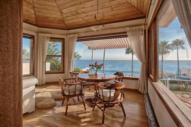 a dining room with furniture and a floor to ceiling window