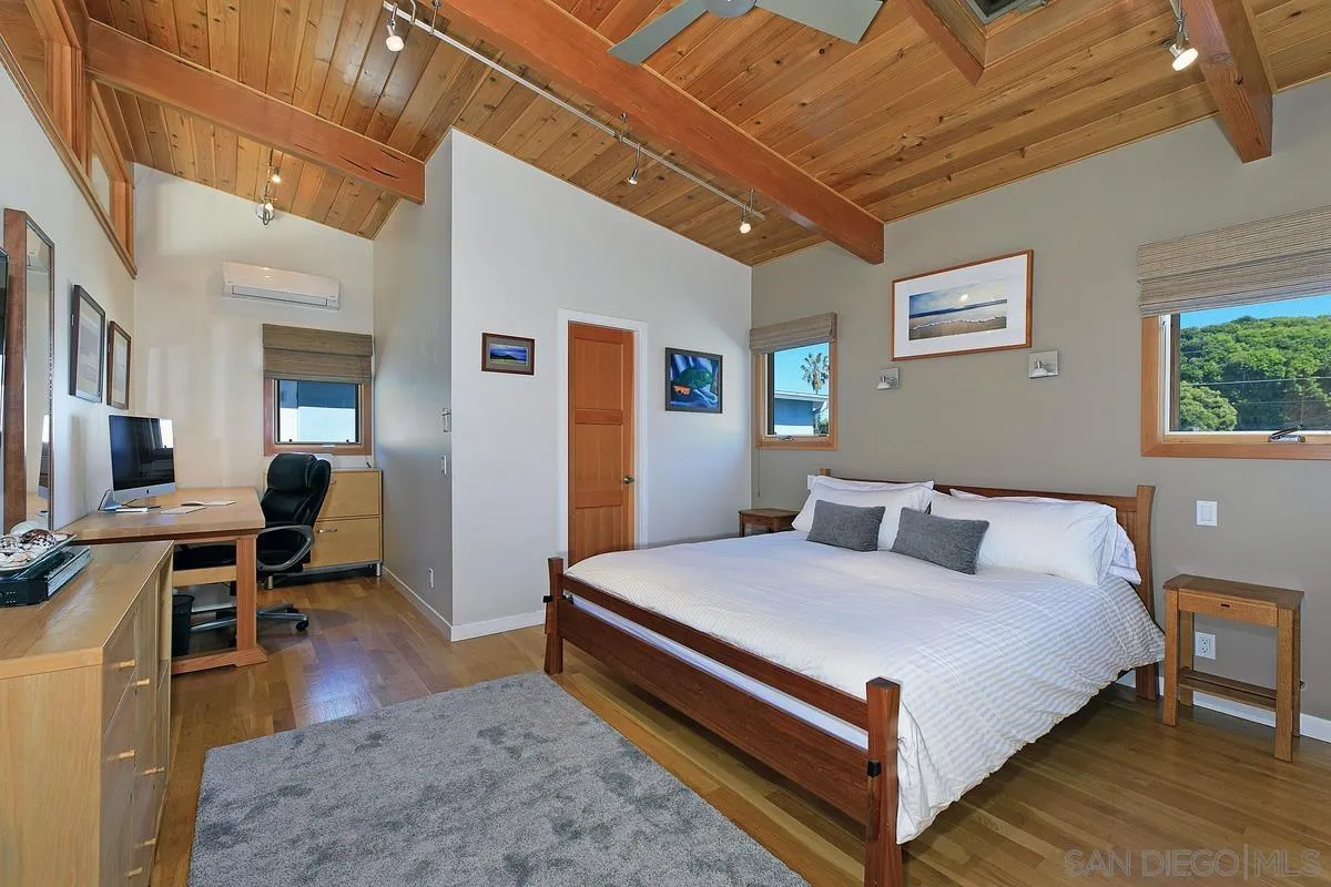 345 Neptune Avenue Encinitas, CA 92024 - Photo 15 of 29 a bedroom with a bed and a table in it