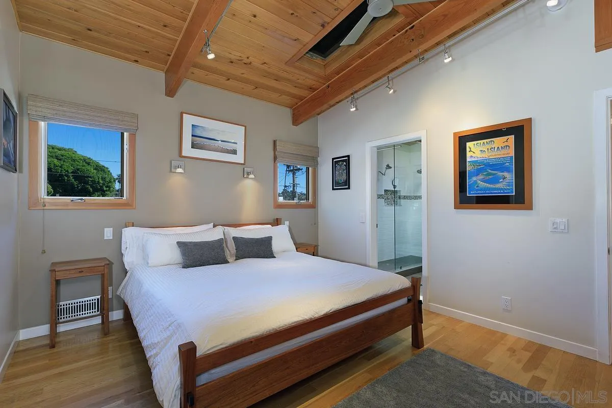 345 Neptune Avenue Encinitas, CA 92024 - Photo 16 of 29 a bedroom with a bed and a painting on the wall