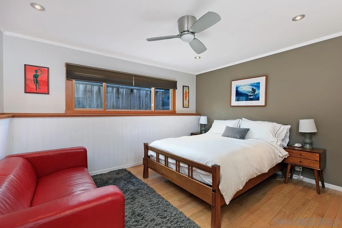 345 Neptune Avenue Encinitas, CA 92024 - Photo 19 of 29 a bedroom with a bed couch and window