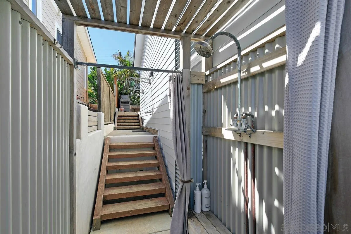 345 Neptune Avenue Encinitas, CA 92024 - Photo 28 of 29 a view of staircase with wooden floor and a chandelier