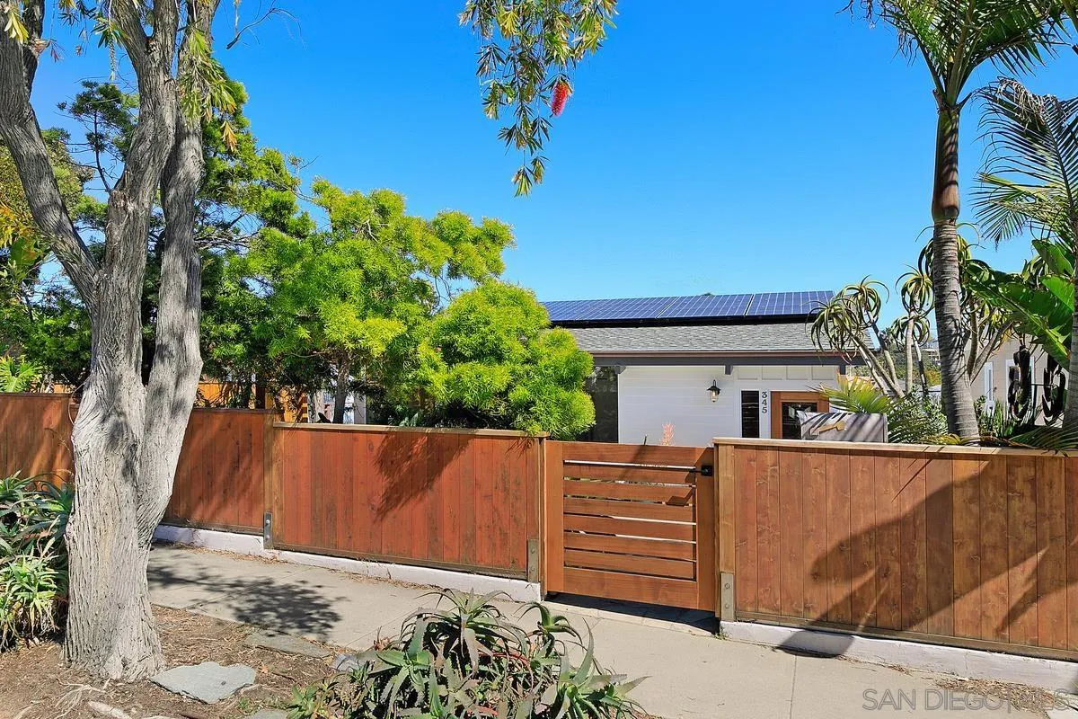 345 Neptune Avenue Encinitas, CA 92024 - Photo 29 of 29 view of backyard with wooden fence and large trees