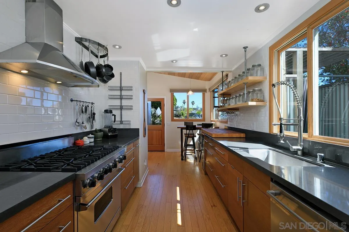 345 Neptune Avenue Encinitas, CA 92024 - Photo 9 of 29 a kitchen with stainless steel appliances granite countertop a stove and a sink