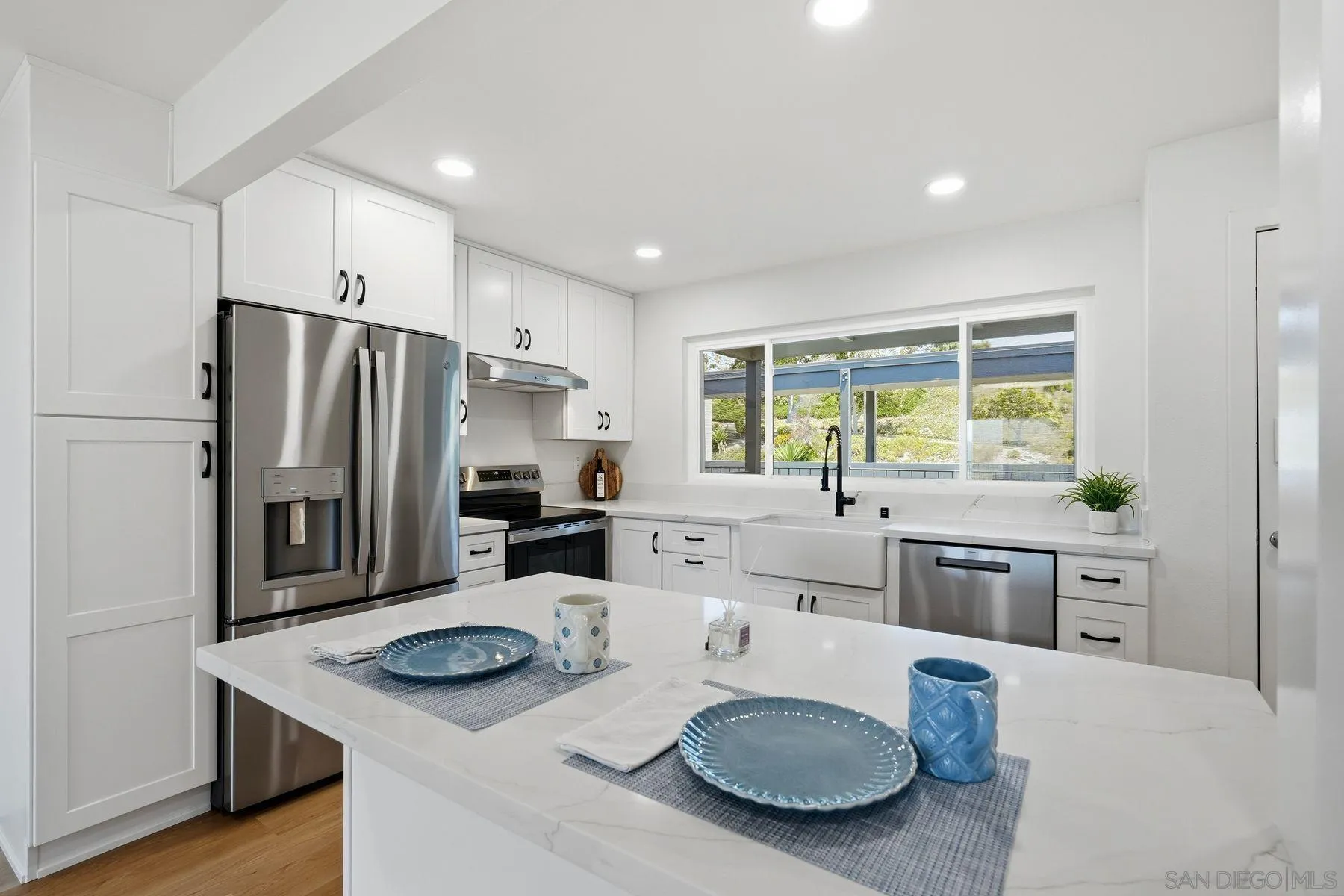 3606 Vista Rey, Unit 46 Oceanside, CA 92057 - Photo 5 of 36 a kitchen with stainless steel appliances granite countertop a kitchen island a stove and a sink