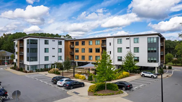 a front view of a building with potted plants