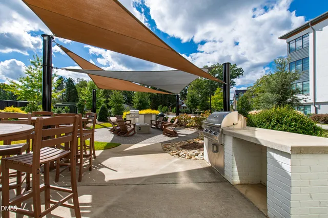 a view of a house with pool and chairs