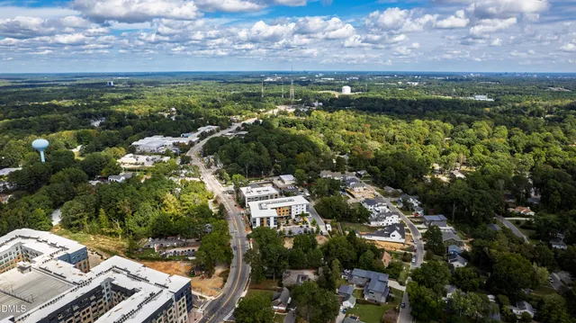 an aerial view of a house with a garden and lake view