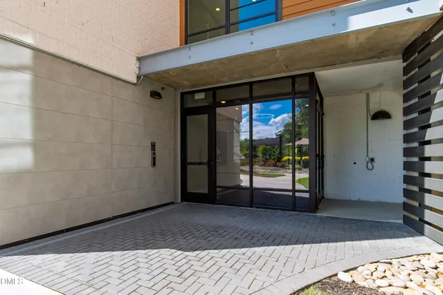 a view of a bedroom with wooden floor and windows
