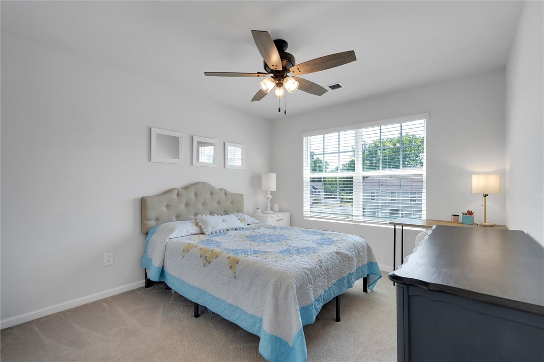 453 Bee Cv Way Pendleton, SC 29670 - Photo 17 of 25 A well-lit guest bedroom features plush carpeting and a large window for abundant natural light.