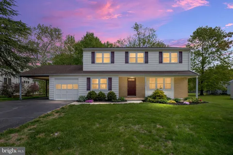 a front view of a house with a garden and yard