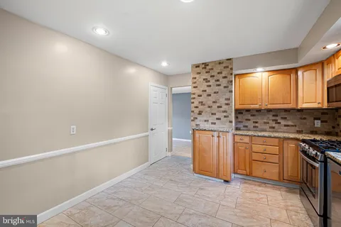 a kitchen with stainless steel appliances granite countertop a sink and a stove