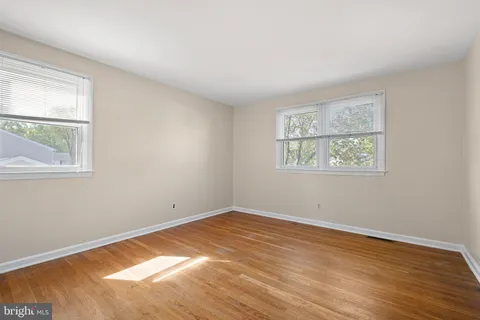 a view of a room with wooden floor and windows