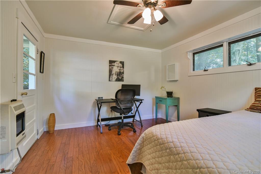 6295 Crabtree Road Clyde, NC 28721 - Photo 18 of 37 a bedroom that has a bed and a chair in it
