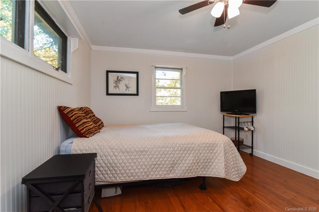 6295 Crabtree Road Clyde, NC 28721 - Photo 19 of 37 a bedroom with a bed and a flat screen tv