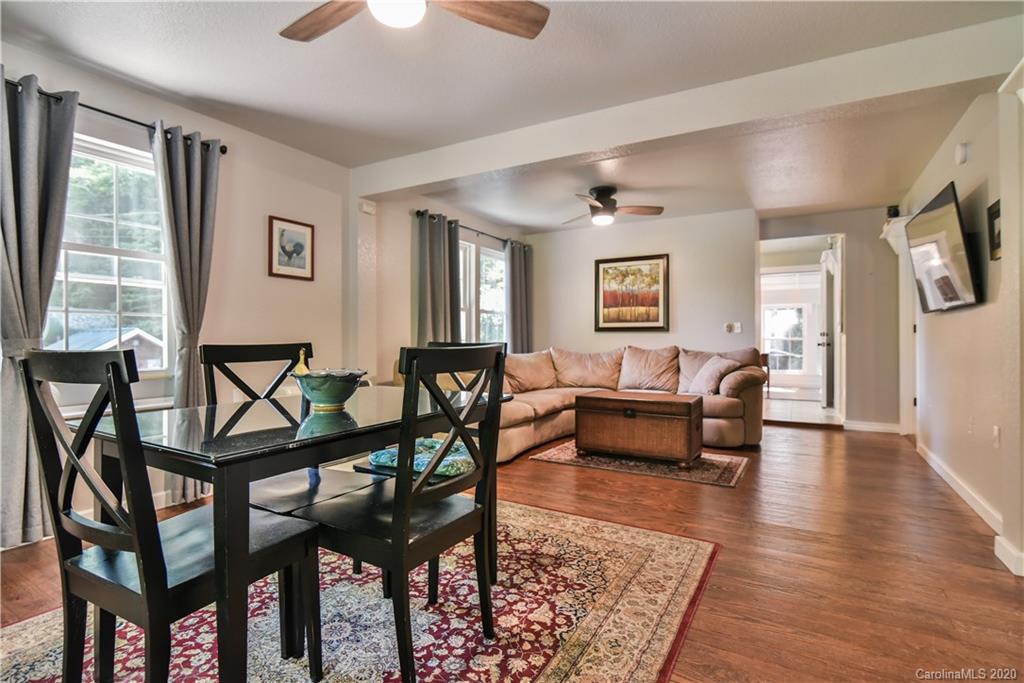 6295 Crabtree Road Clyde, NC 28721 - Photo 21 of 37 a living room with a couch and a chandelier