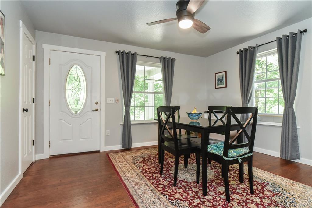 6295 Crabtree Road Clyde, NC 28721 - Photo 22 of 37 a view of a dining room with furniture window and wooden floor