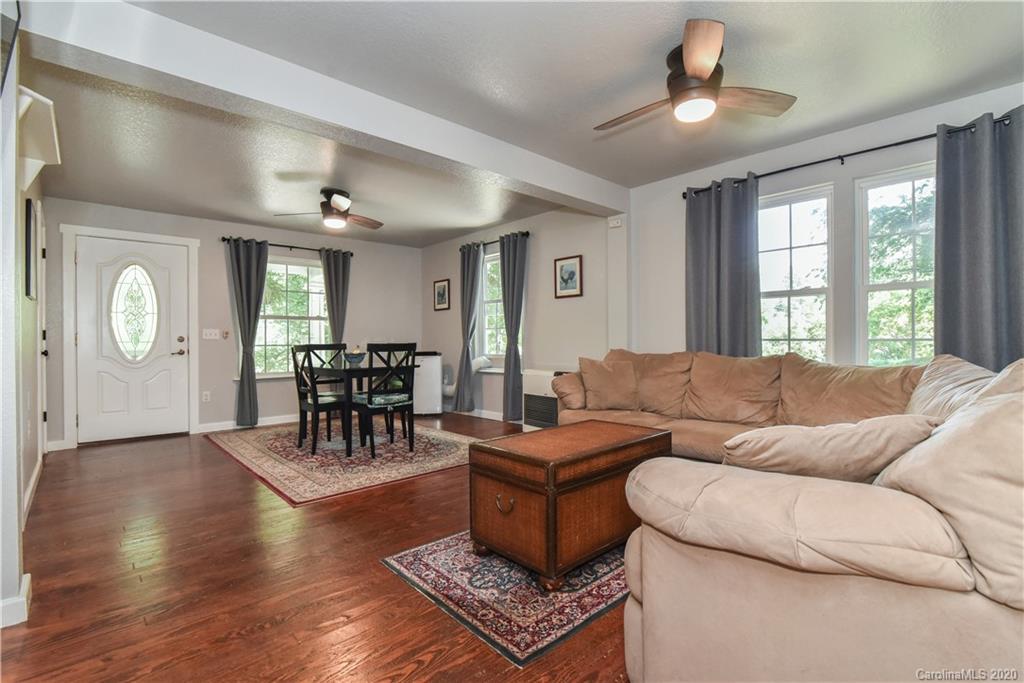 6295 Crabtree Road Clyde, NC 28721 - Photo 23 of 37 a living room with furniture a clock on wall and a window
