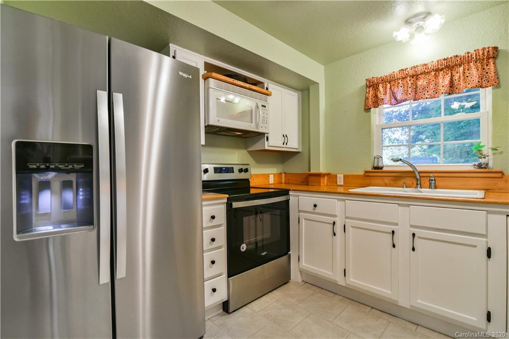 6295 Crabtree Road Clyde, NC 28721 - Photo 26 of 37 a kitchen with stainless steel appliances granite countertop a refrigerator and a sink