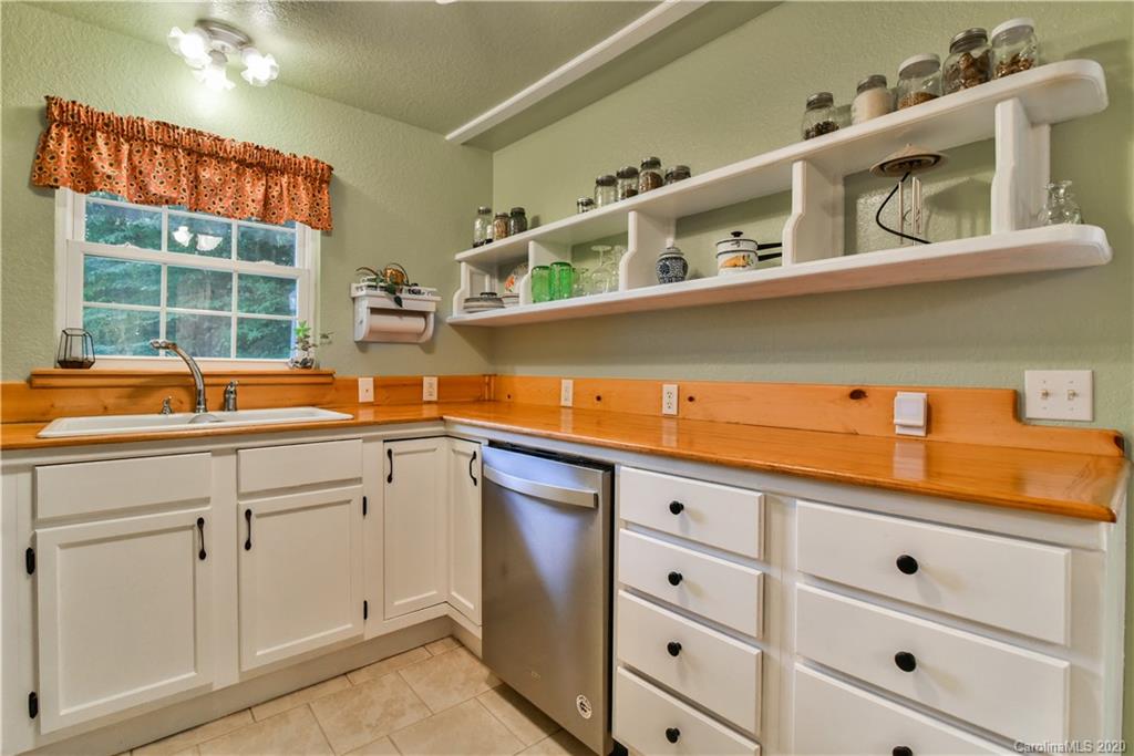 6295 Crabtree Road Clyde, NC 28721 - Photo 27 of 37 a kitchen with stainless steel appliances cabinets and a window