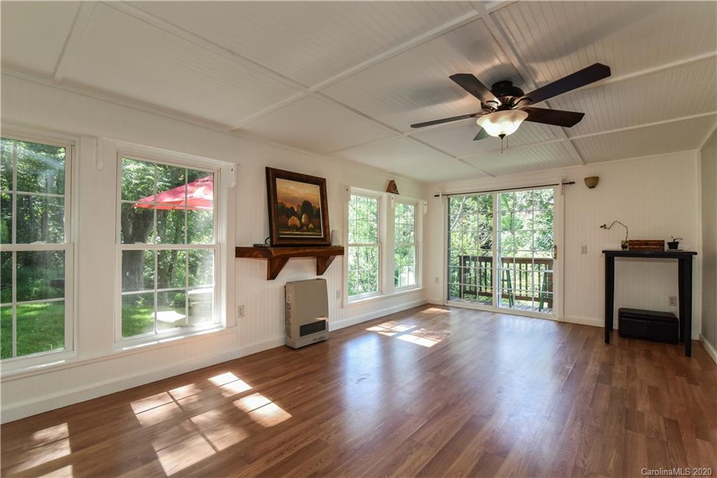 6295 Crabtree Road Clyde, NC 28721 - Photo 29 of 37 a view of an empty room with a window and wooden floor