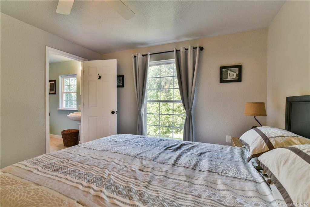 6295 Crabtree Road Clyde, NC 28721 - Photo 31 of 37 a bedroom with a bed and a window