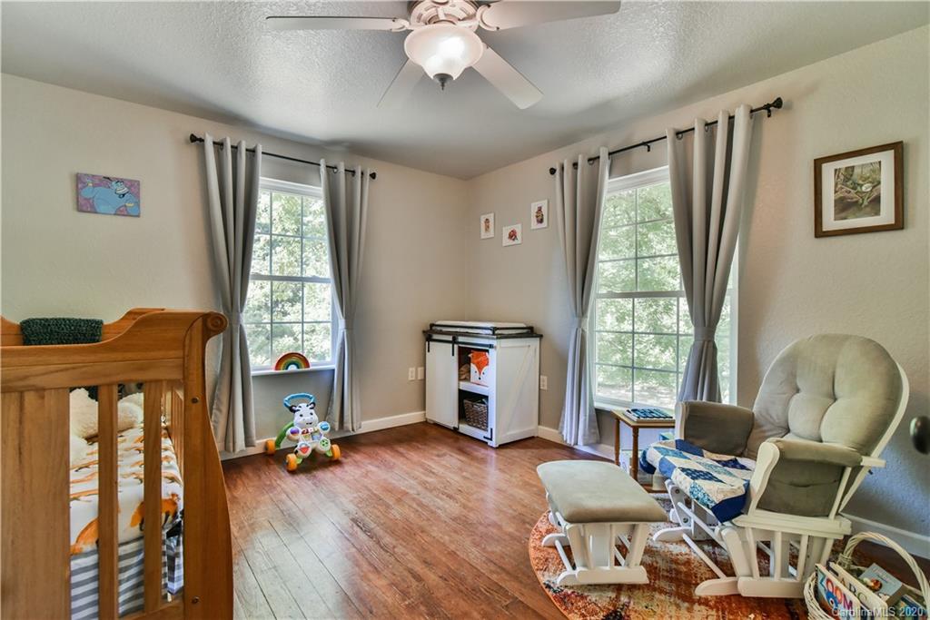 6295 Crabtree Road Clyde, NC 28721 - Photo 35 of 37 a living room with furniture and a wooden floor