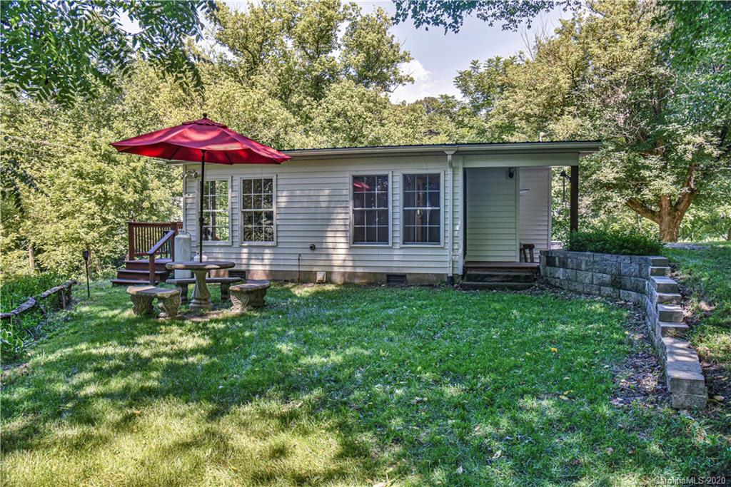 6295 Crabtree Road Clyde, NC 28721 - Photo 5 of 37 a backyard of a house with table and chairs