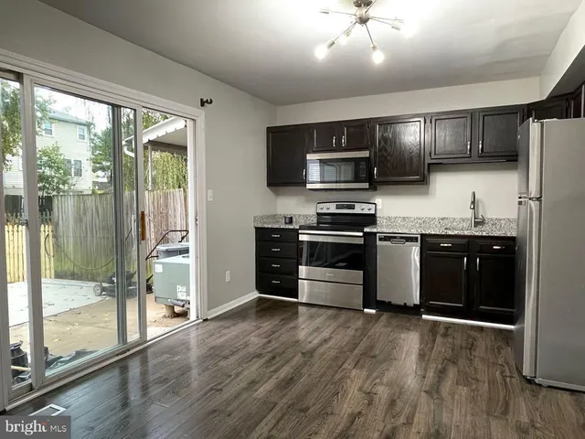 a kitchen with stainless steel appliances granite countertop a stove top oven and sink