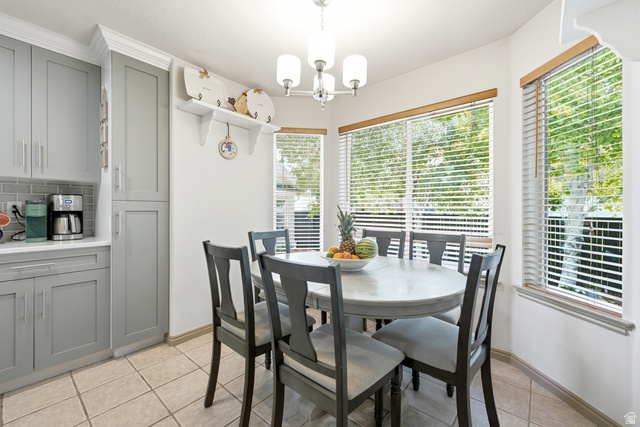 5196 Rodeo Circle Oakley, UT 84055 - Photo 18 of 57 Dining area featuring large windows, a chandelier, and tile flooring