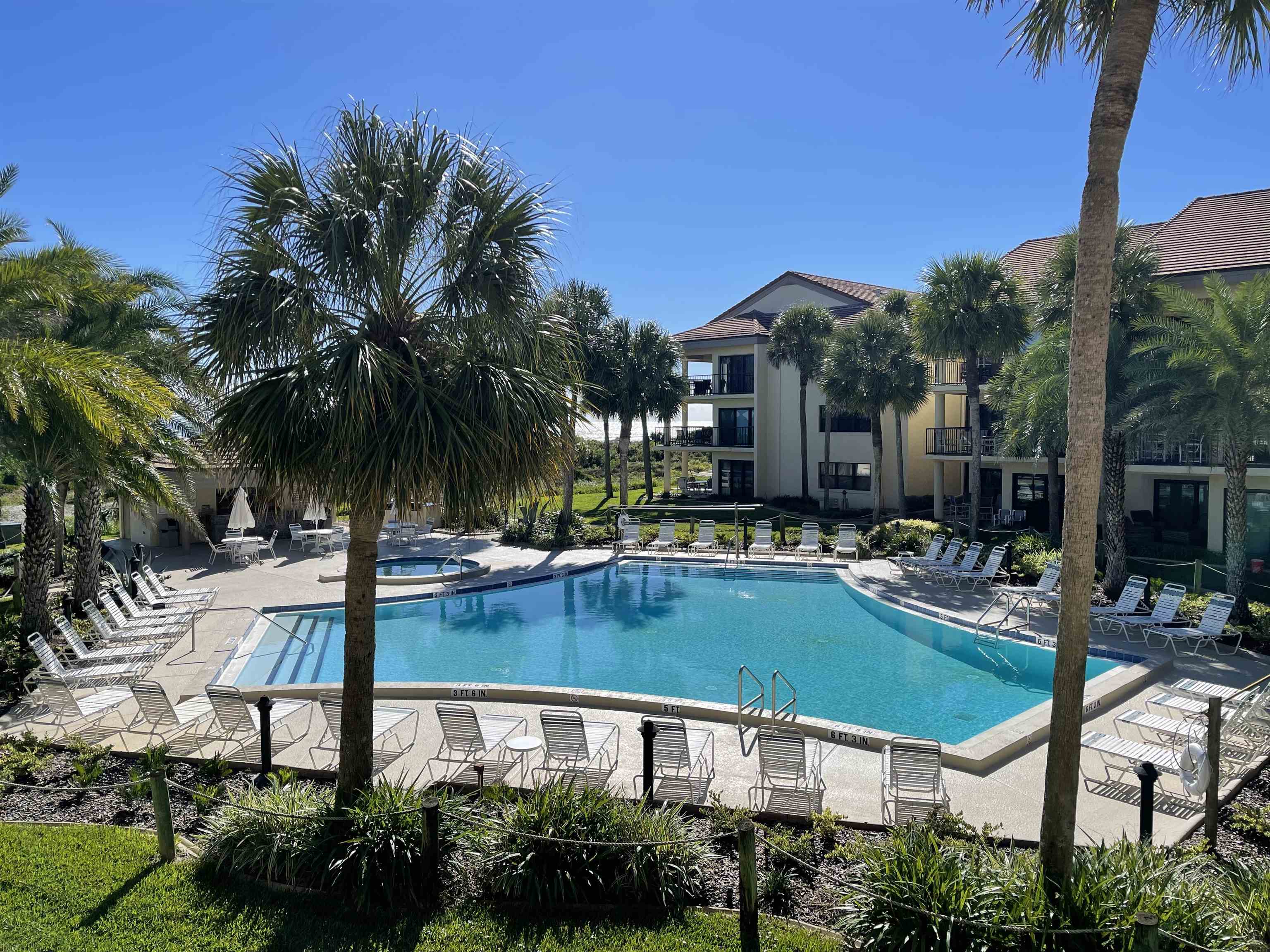 a view of a house with swimming pool and sitting area