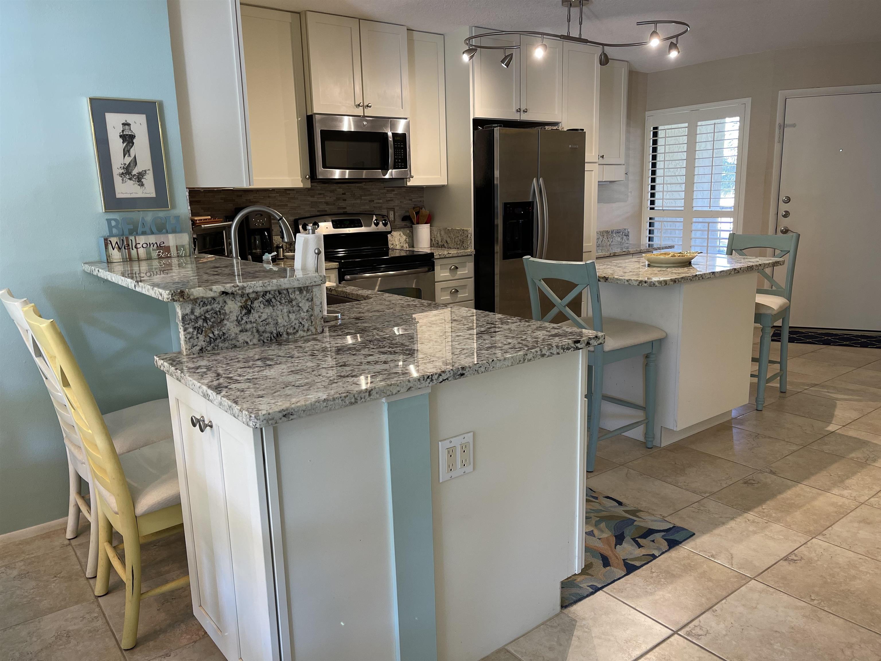 213 Pacifica Vista Way St. Augustine, FL 32080 - Photo 14 of 29 a kitchen with stainless steel appliances granite countertop a sink stove and refrigerator