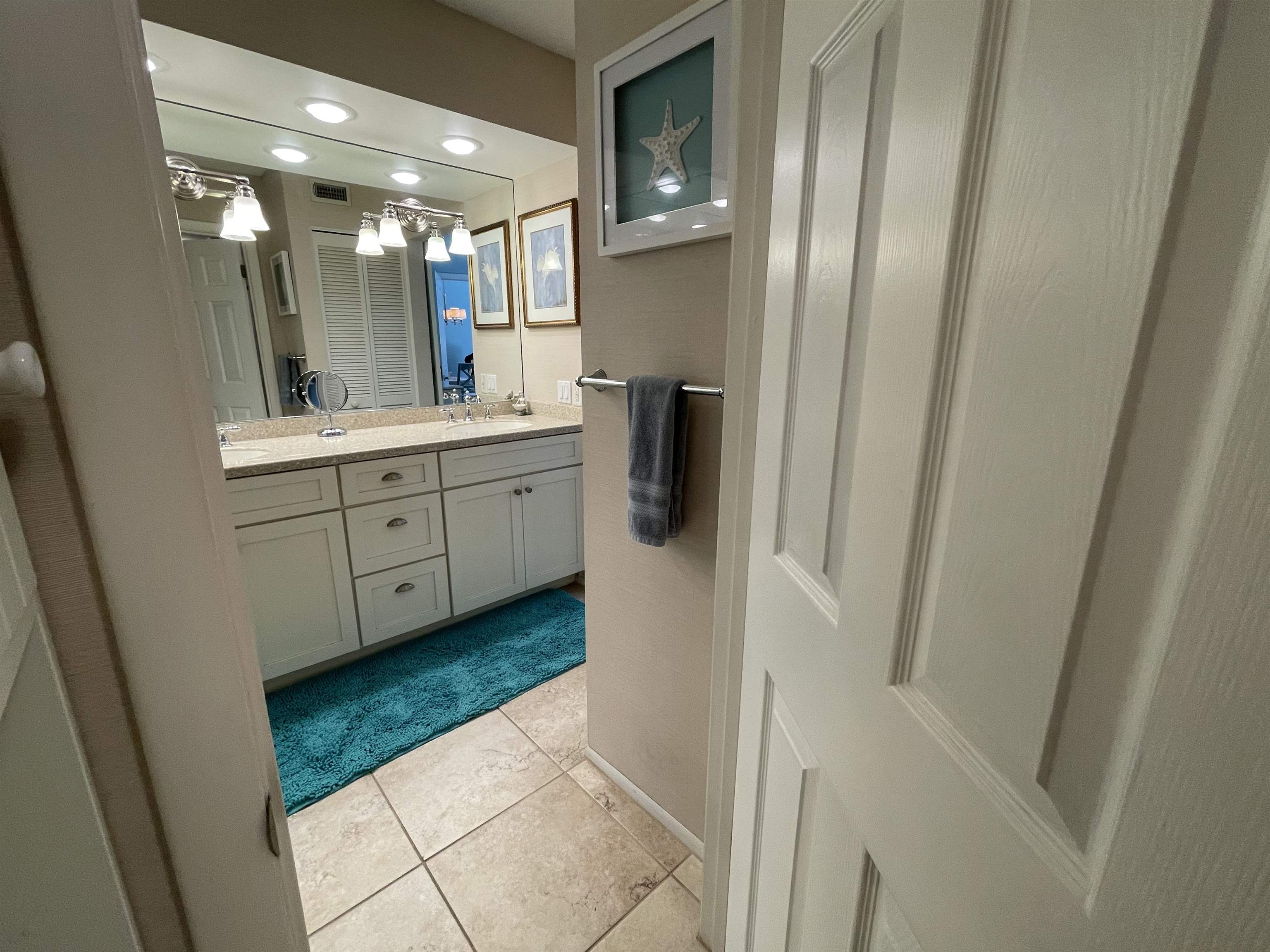 213 Pacifica Vista Way St. Augustine, FL 32080 - Photo 26 of 29 a bathroom with a double vanity sink and mirror