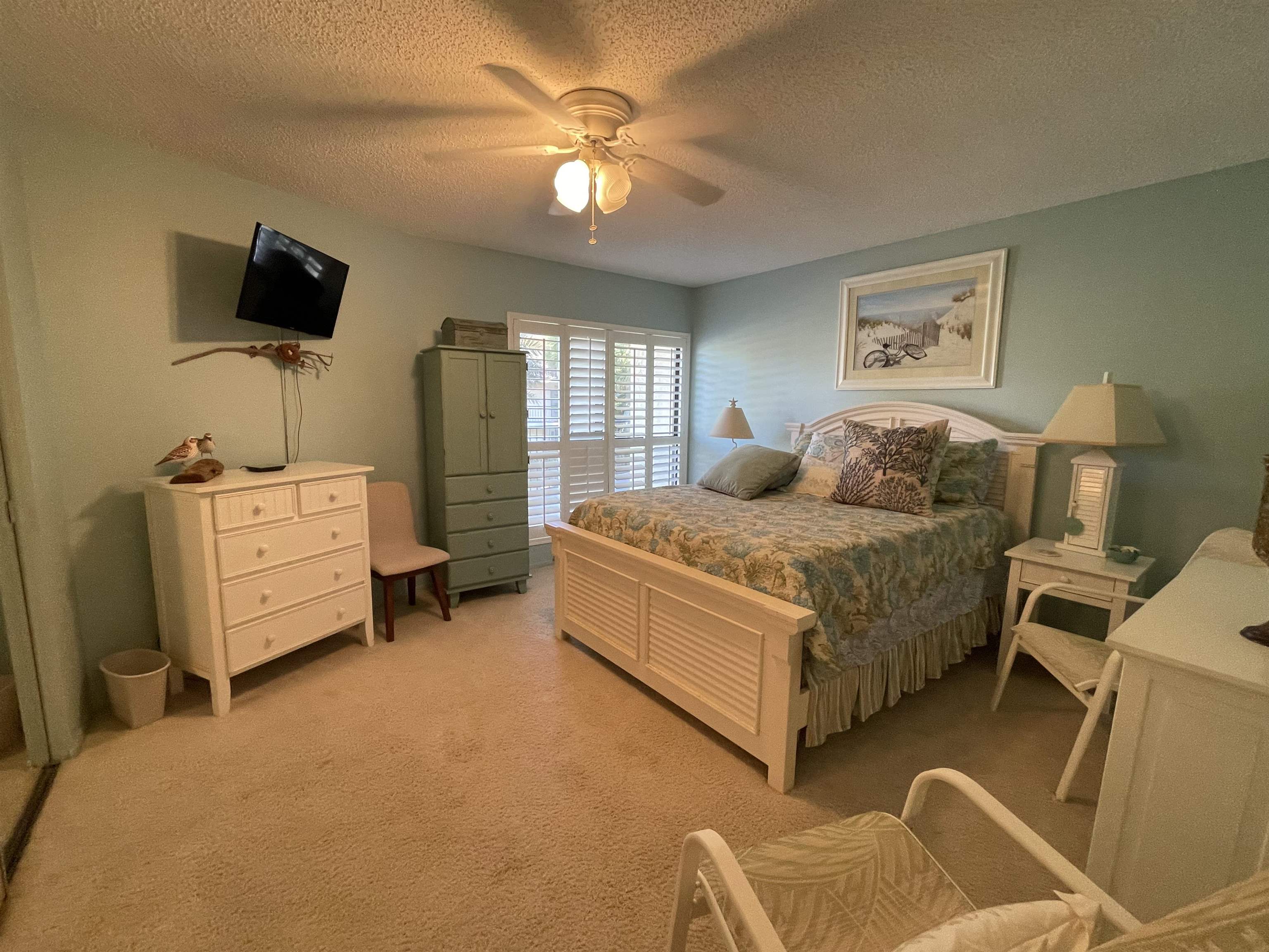 213 Pacifica Vista Way St. Augustine, FL 32080 - Photo 27 of 29 a bedroom with a bed and a flat tv screen on the dresser