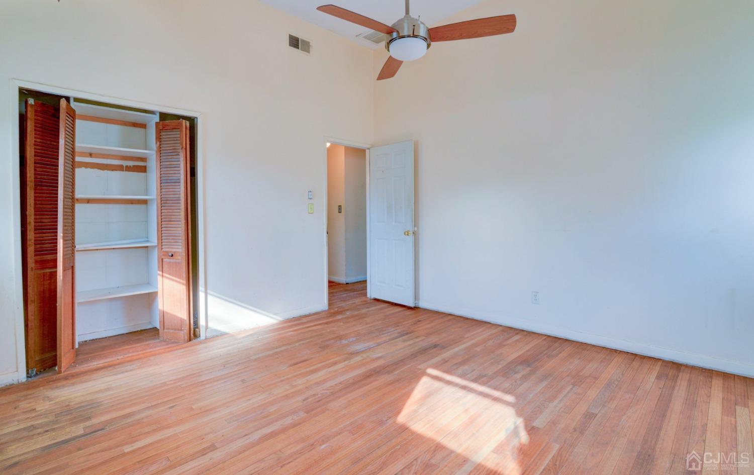 537 Ford Avenue Fords, NJ 08863 - Photo 14 of 31 a view of an empty room with wooden floor and a window