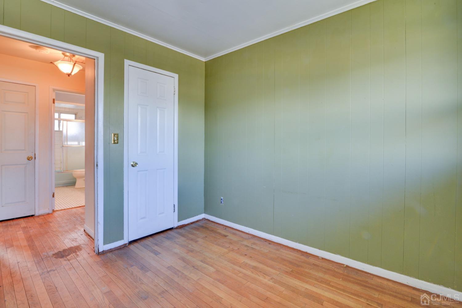 537 Ford Avenue Fords, NJ 08863 - Photo 16 of 31 an empty room with wooden floor and a window