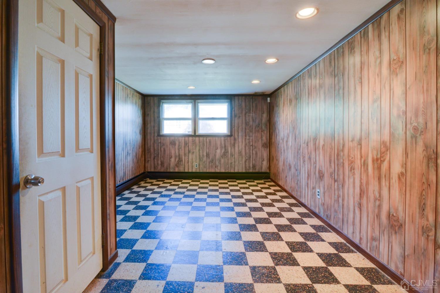 537 Ford Avenue Fords, NJ 08863 - Photo 20 of 31 a view of a hallway with a black white checkered floor and a large window