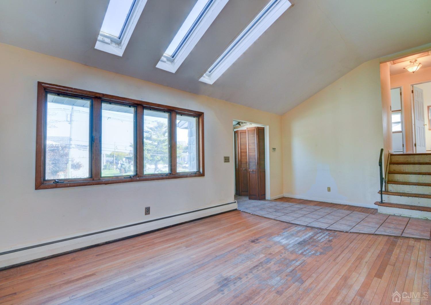 537 Ford Avenue Fords, NJ 08863 - Photo 4 of 31 a view of an empty room with wooden floor and a window