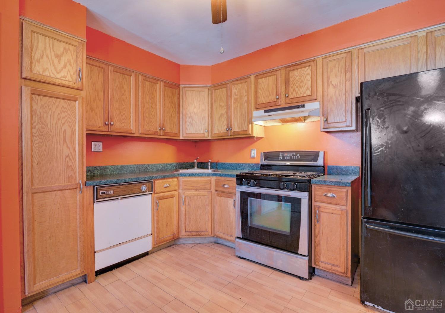 537 Ford Avenue Fords, NJ 08863 - Photo 8 of 31 a kitchen with stainless steel appliances granite countertop a refrigerator a stove a sink and a microwave