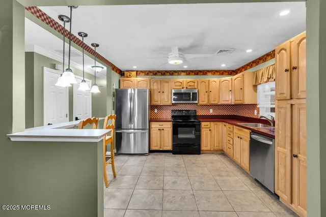 a kitchen with stainless steel appliances granite countertop a sink and cabinets