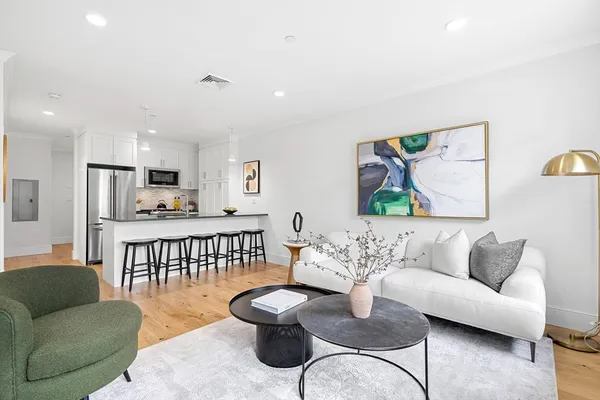 a living room with furniture and a wooden floor