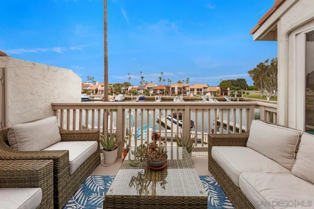 a balcony with furniture and a potted plant