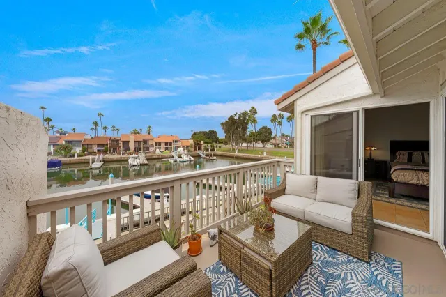 a view of a balcony with couches and wooden floor