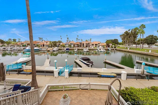 a view of a lake with outdoor seating and city view