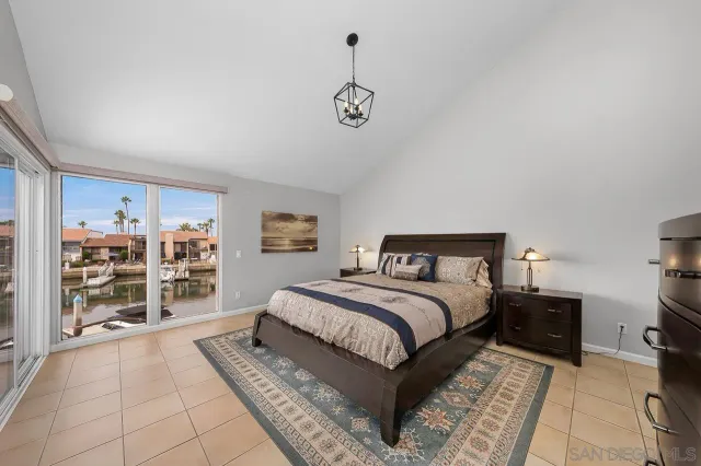 a spacious bedroom with a bed a dresser and a book shelf