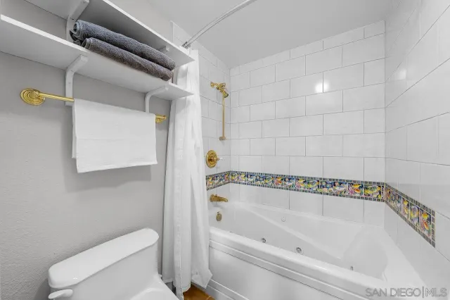 a bathroom with a bathtub and toilet