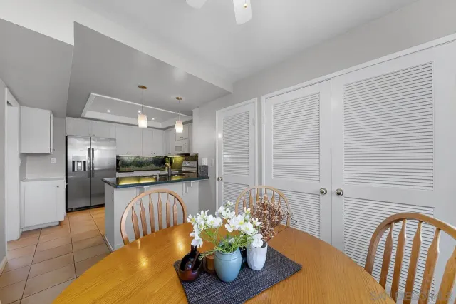 a kitchen with stainless steel appliances granite countertop a refrigerator a sink a stove and a cabinets