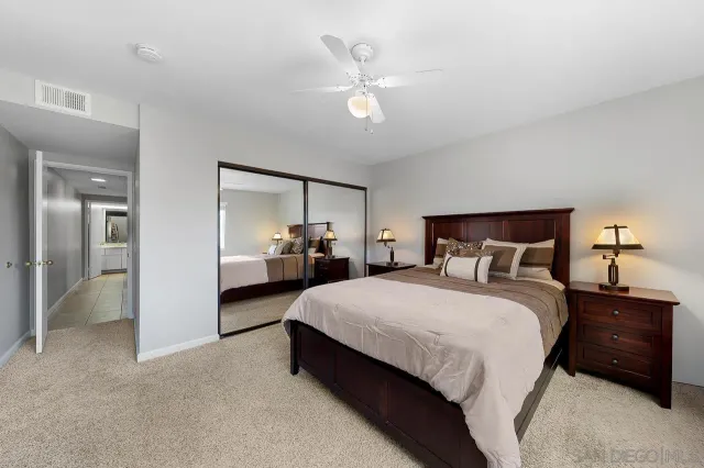 a bedroom with bed and a chandelier